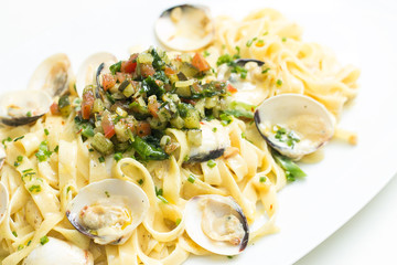 Cooked pasta with scallops and mixed vegetable topping
