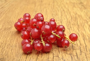 Red currant on wooden background