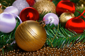 Variety of christmas balls on green fir-tree branch