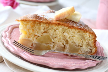 Slice of homemade gluten free apple sponge cake on pink plate