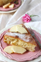Slice of homemade apple sponge cake on pink plate
