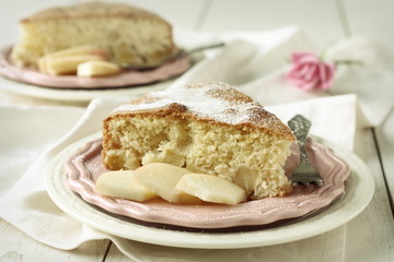 Slice of homemade apple sponge cake on pink plate