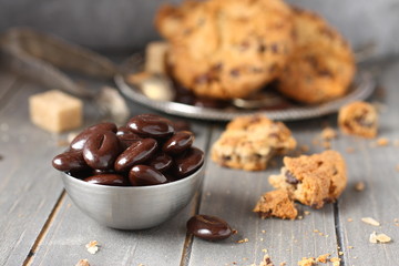 Chocolate candy with chocolate chip cookies on wooden background