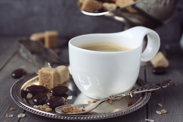 Cup of espresso, sugar cubes and chocolate candy