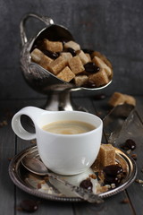 Cup of coffee, sugar cubes and chocolate candy