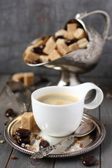 Cup of coffee, sugar cubes and chocolate candy