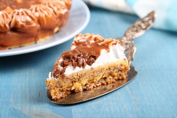 Slice of almond cake with chocolate and cream