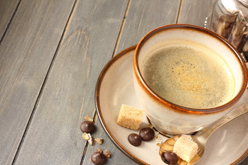 Cup of coffee, sugar cubes and chocolate drops
