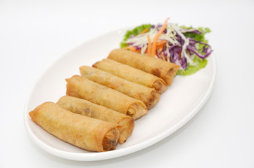 Fried spring rolls on white plate.