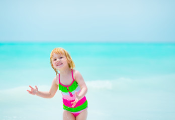 Portrait of happy baby girl at seaside