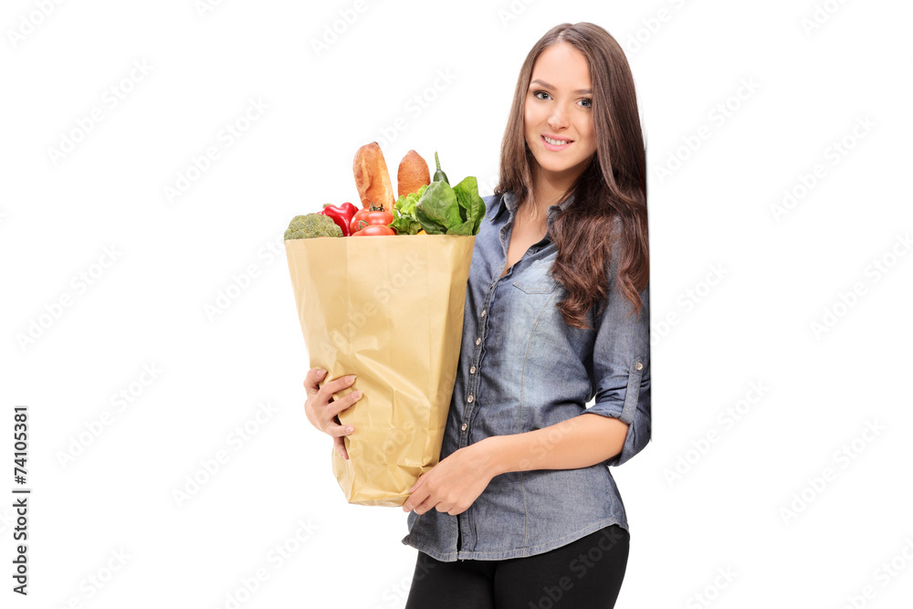 Wall mural Young girl holding a grocery bag