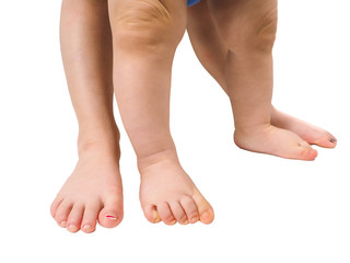 Barefoot young children standing towards isolated white backgrou