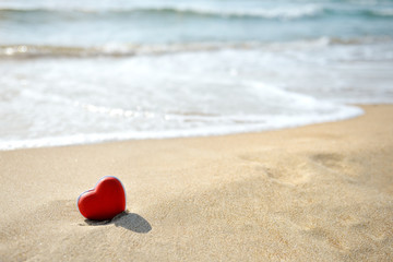 red heart on sea beach - love relax concept