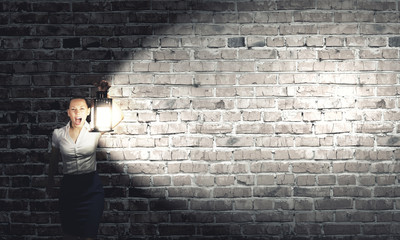 Businesswoman with lantern