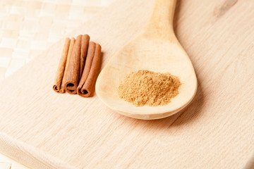 cinnamon sticks and cinnamon powder on a wooden spoon