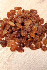 Raisins on wood plank, background