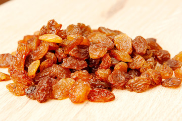 Raisins on wood plank, background