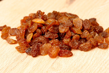 Raisins on wood plank, background