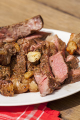 Plate of Grilled Steak and Garlic with Red Napkin