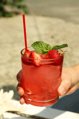 Refreshing cocktail in hand