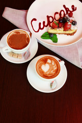 Cup of coffee with cute drawing in cafe