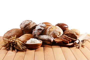 Fresh bread on table on white background
