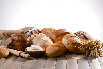 Fresh bread on table on white background