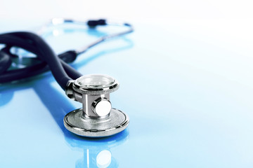 Stethoscope on light blue background