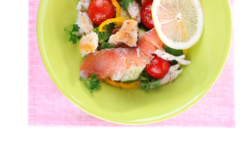 Appetizing fish salad with vegetables on plate isolated on