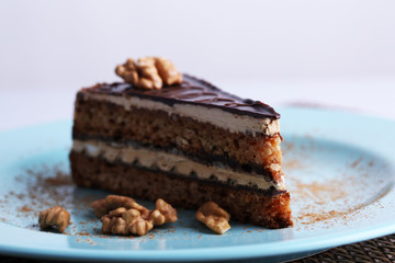 Delicious chocolate cake on plate on table close-up