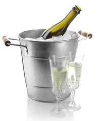 Bottle of champagne in metal ice bucket and two glasses