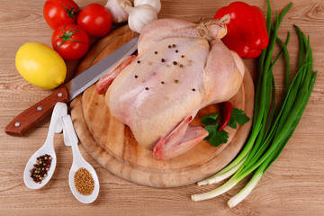 Raw chicken on wooden table