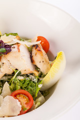 tasty fresh caesar salad with grilled chicken and parmesan