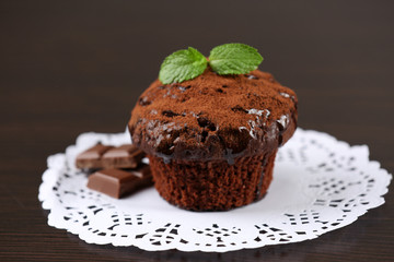 Yummy chocolate cupcake on table