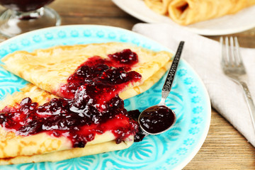 Plate of delicious pancakes with berry jam