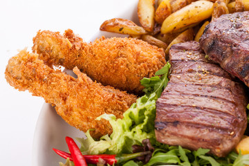 Platter of mixed meats, salad and French fries