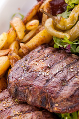 Platter of mixed meats, salad and French fries