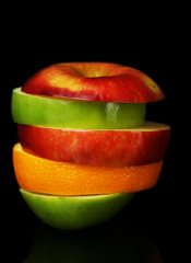 Fresh sliced fruit isolated on black