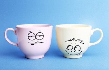Emotional cups on blue background