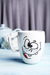 Emotional cup on wooden table