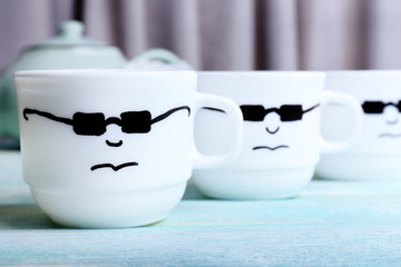 Emotional cups on wooden table