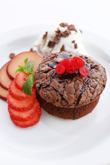 Fototapeta na wymiar Hot chocolate pudding with ice-cream and fruits, close-up