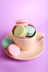 Assortment of gentle colorful macaroons in colorful mug