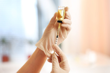 Doctor with medical syringe in hands, getting ready for