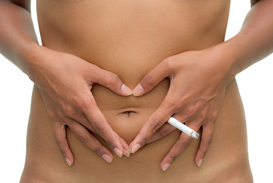 woman with cigarette make symbol heart on her belly