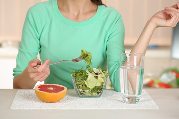 Girl and dietary food at table close-up