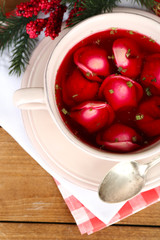 Traditional polish clear red borscht with dumplings and