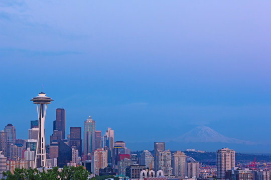 Seattle city landmarks and Mt. Rainier at sunset.
