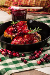 Cranberries and cast iron skillet with chicken