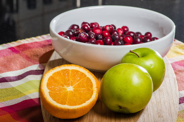 Bowl of cranberries with apples and oranges